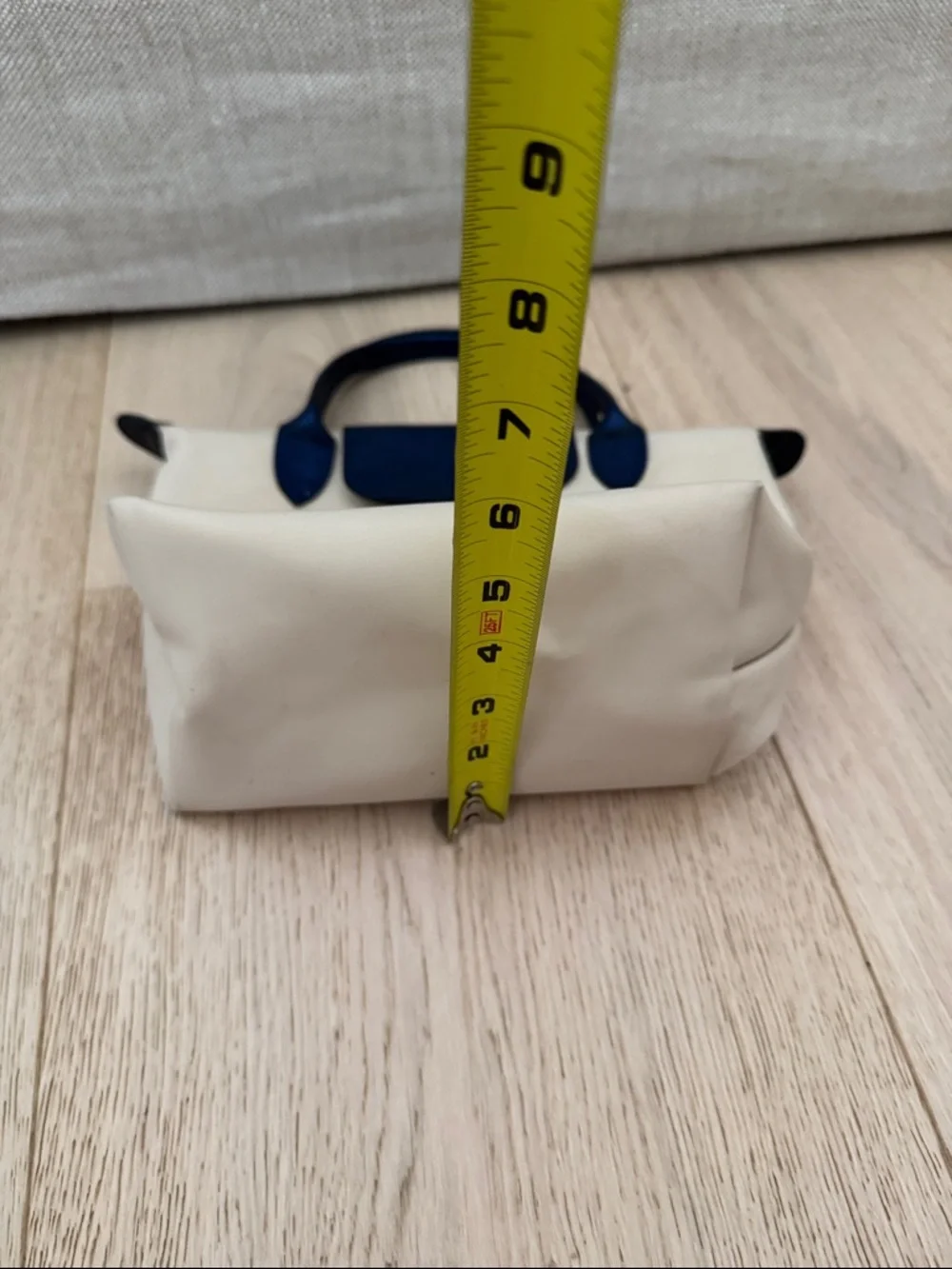 Longchamp Small Le Pliage Cream Tote with Navy Trim. Top zip with snap flap.